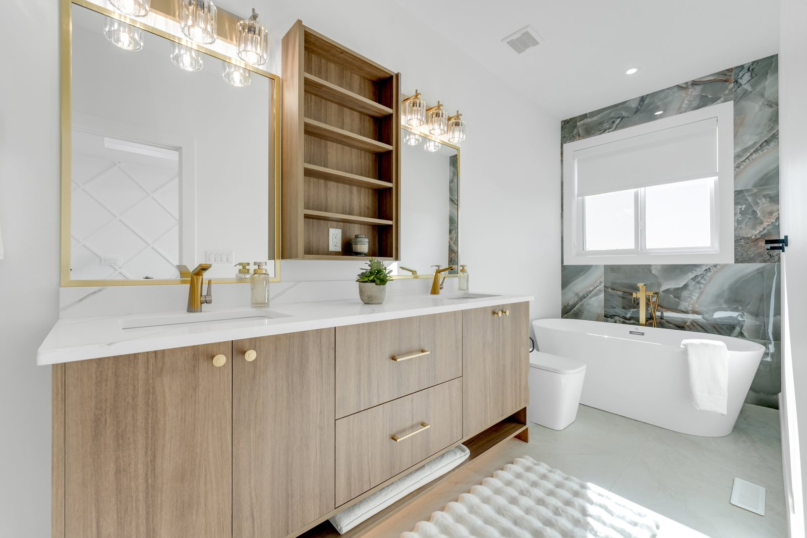 Spa-inspired ensuite with a freestanding tub and marble feature wall