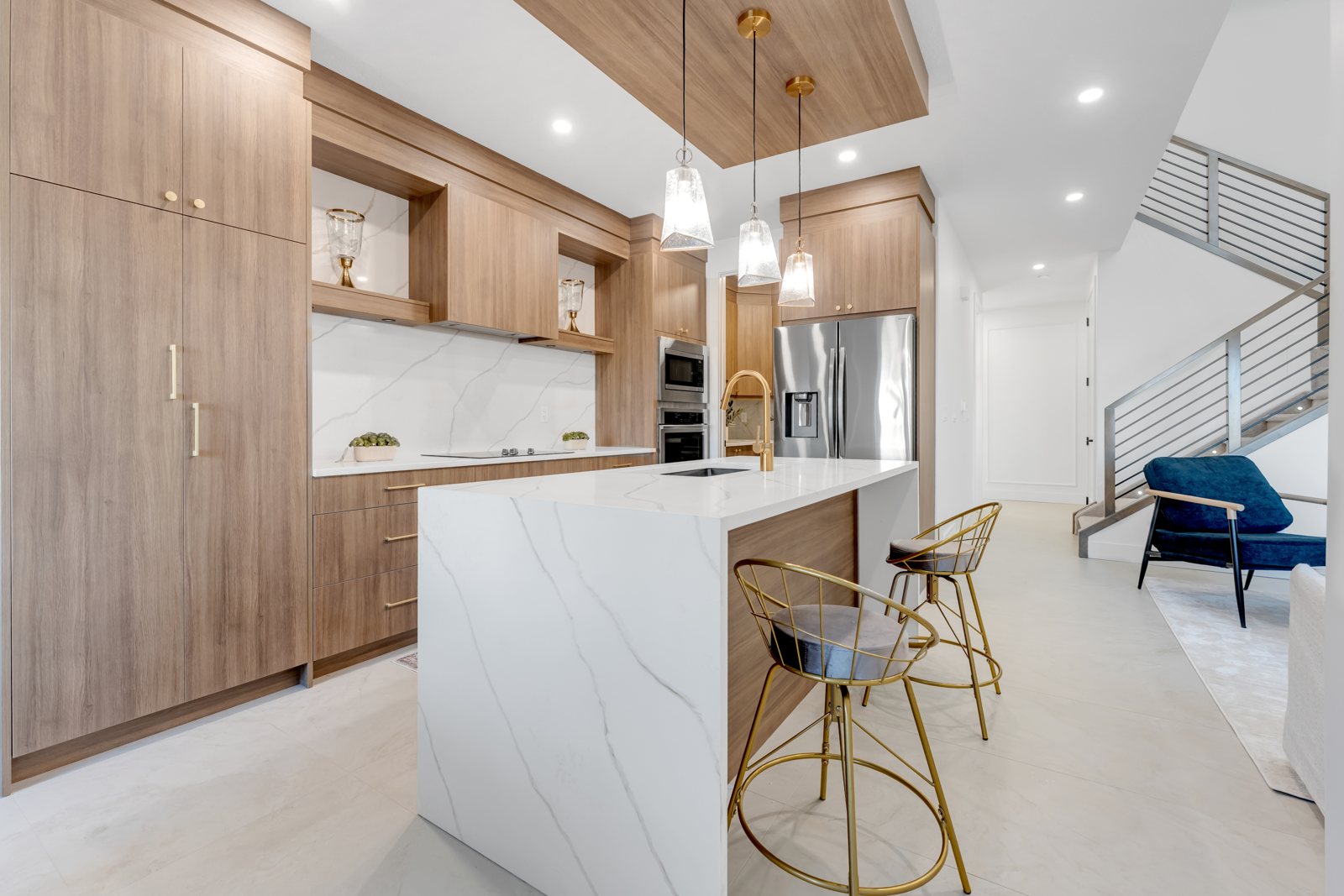 Designer kitchen with a marble waterfall island and gold accents